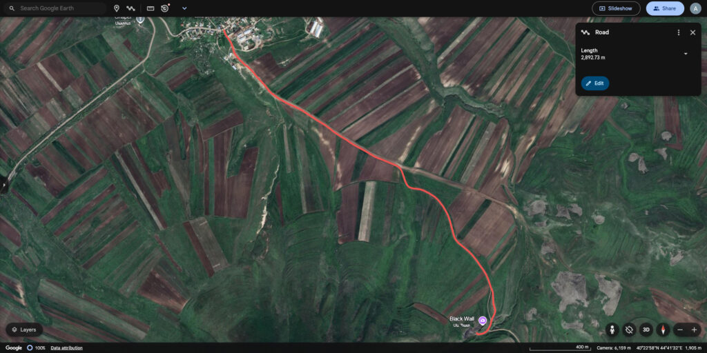 A screenshot of a map website, Google Earth, with a path highlighted in red running through the landscape.